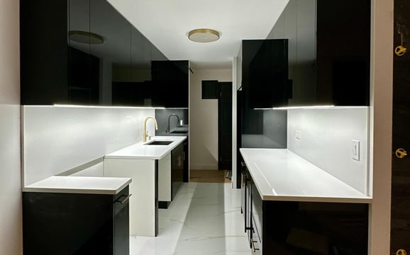 a kitchen with a long counter top and a sink