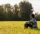 a man sitting in a field 