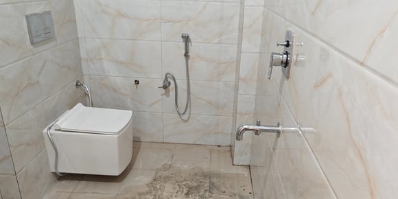 a bathroom with a toilet and a toilet paper towel