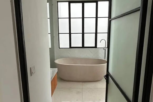 terrazzo bathroom in Balinese villa with natural stone and outdoor view