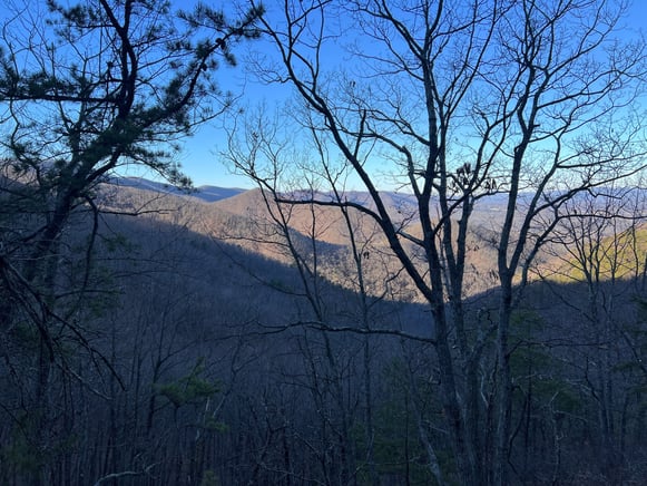 a view of a mountain range with trees and mountains in the background from spec mine trail