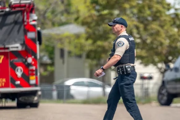 Ada County Sheriff Deputy crossing the street behind a fire truck in Idaho.