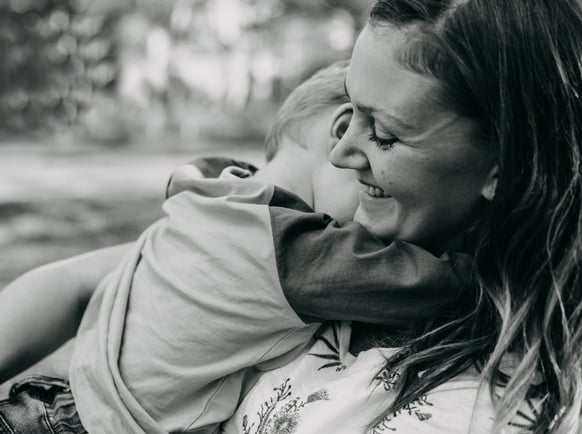 a woman holding a child in her arms