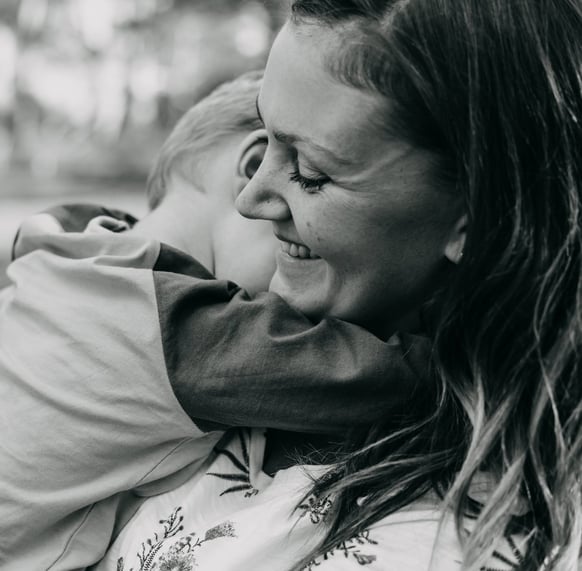 a woman holding a child in her arms