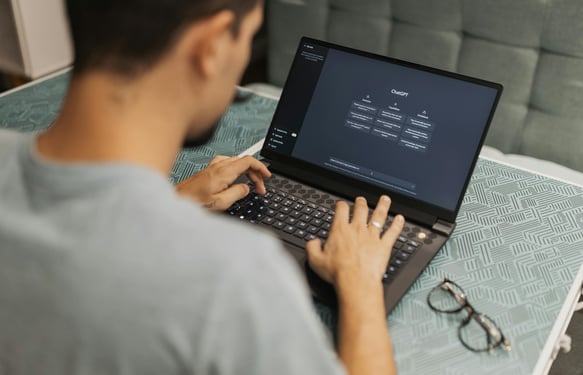 a man sitting on a couch with a laptop computer