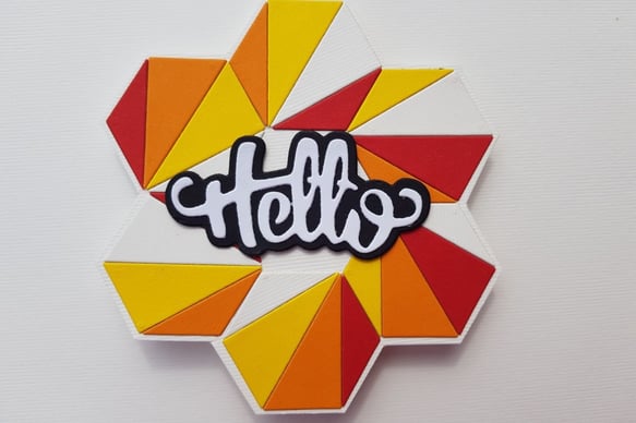 Hexagonal design with red, orange, and yellow triangles surrounding a stylized "hello" in black and 