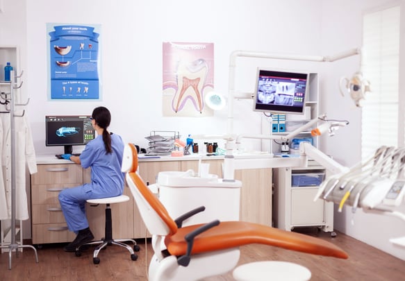a woman in a chair in a dental room