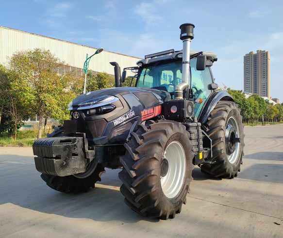a tractor with a large tire on the side of the road