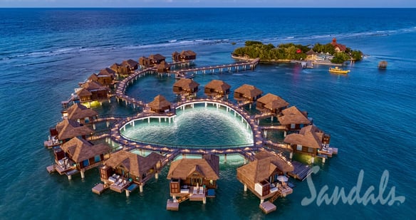 Coastal Vibe Travel - Sandals Weddings - a circular shaped fountain in the middle of a body of water