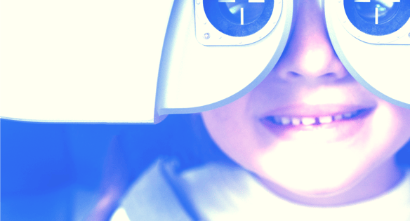 a young girl having eyes test