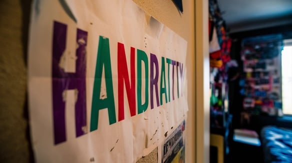 a poster with the inscription “HANDRATTY” in a room