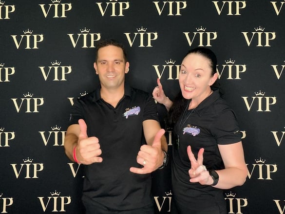 Carly and Kahn from SweetAz Co. posing in front of the VIP backdrop in the open air digital photo booth at an event in Brisba