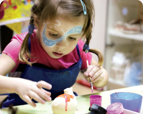 a small kid painting