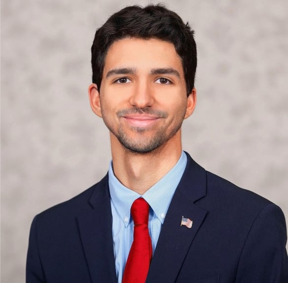 a man in a suit and tie with a red tie