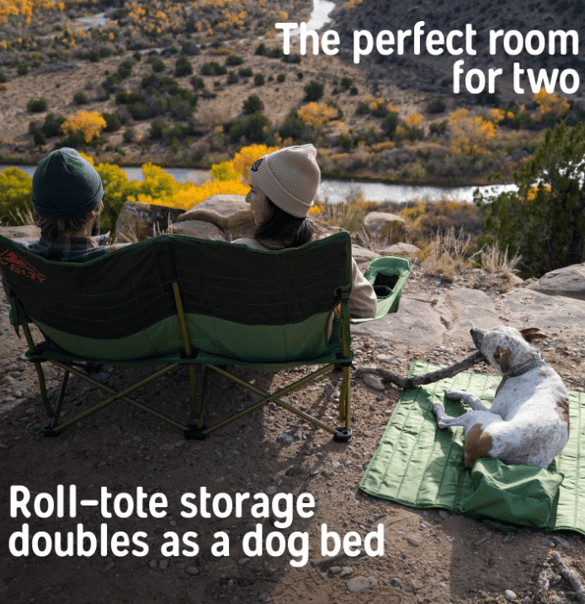 Camping couple sitting in a Kelty loveseat camping chair, with dog using roll-tote bag as bed