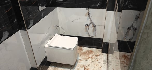 a bathroom with a toilet and a shower