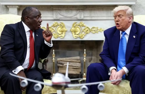 a man in a suit and tie is sitting in a chair