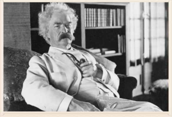 a man in a suit and tie sitting on a couch