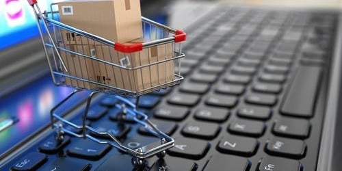 a shopping cartonce with a cartonce in front of a laptop