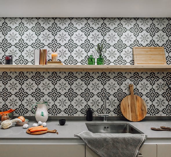 Open-plan kitchen with patterned tiles, neutral tones in Rute apartment interior design