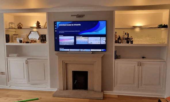 Professional TV wall mounting service. TV on wall above a fireplace