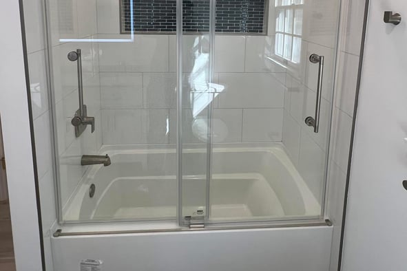 a new bathroom with a glass shower and a tub installed in South Jersey