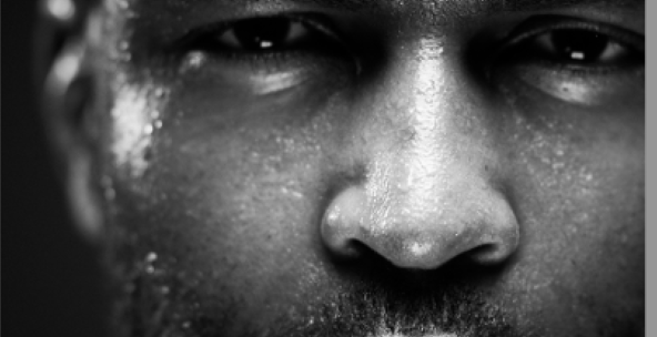 a man with a beard who is sweating