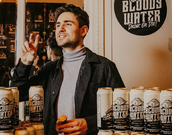 Man at a Business Launch with His Products