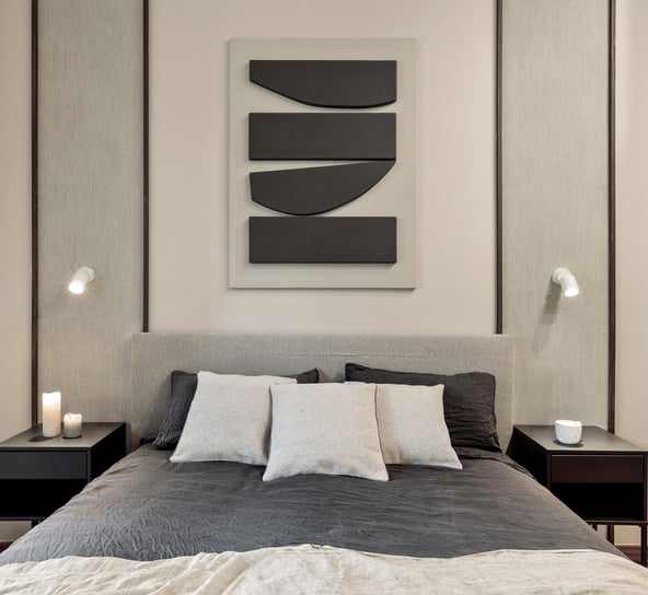 Elegant bedroom design with custom wall panels and bold decor details, designed by SAVIA