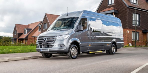 Silver Mini Bus parked on the side of a road