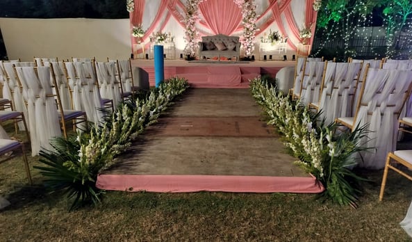 a wedding ceremony with a pink and white floral arrangement