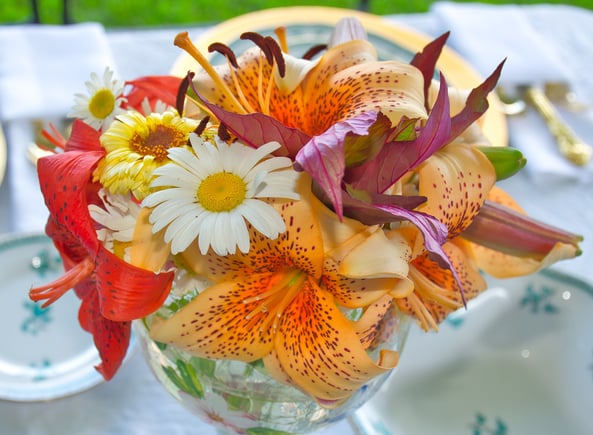 a vase with flowers on a table as wedding decoration