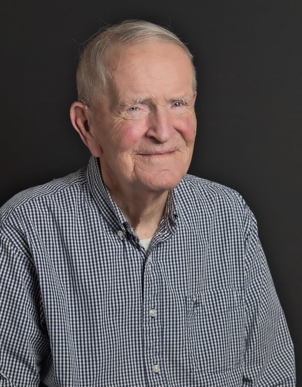 an old man in a blue shirt and a white shirt