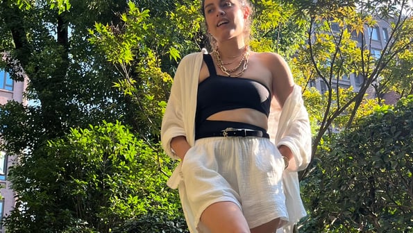 Cynthia Scellos, timeless styless fashion for women in a black top and white shorts