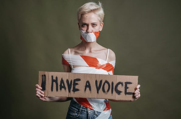 a woman with a mask on her face and a sign that says i have a