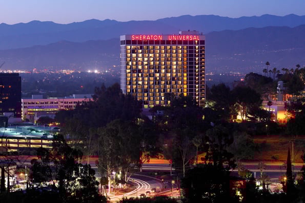 a city skyline view of Sheraton Hotel on a neon sign 