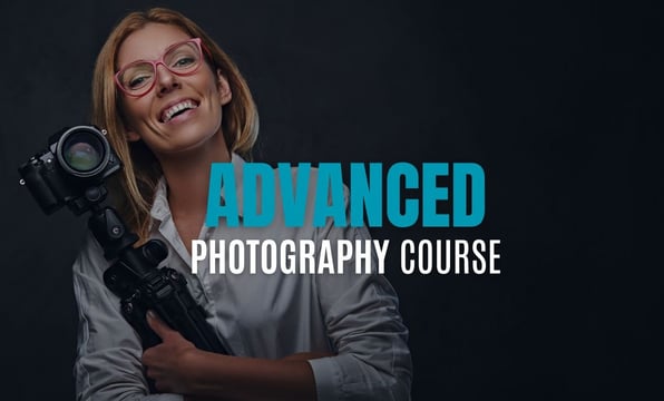 Smiling woman holding a DSLR camera and tripod with text overlay reading Advanced Photography Course.