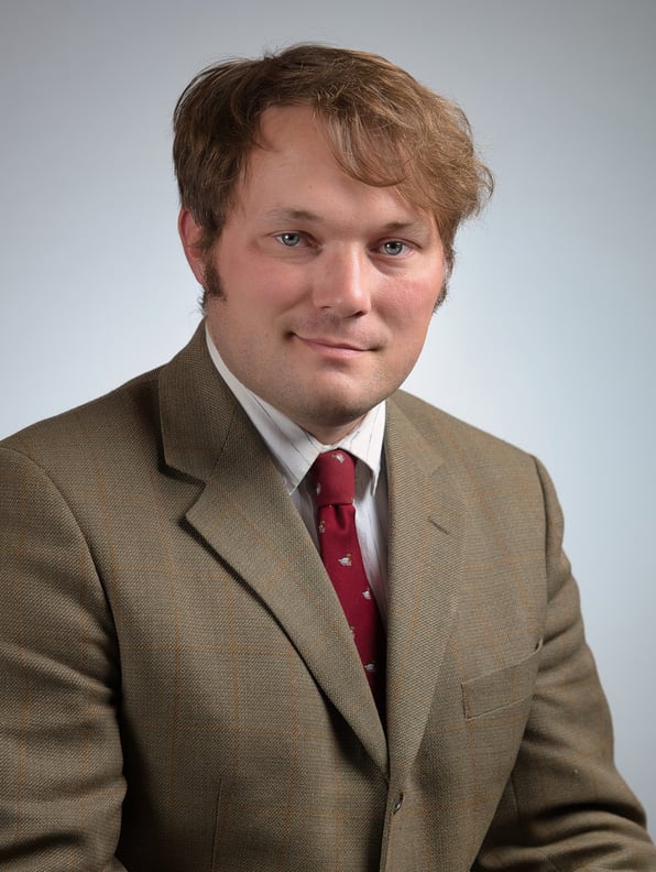 a man in a suit and a red tie and a white shirt