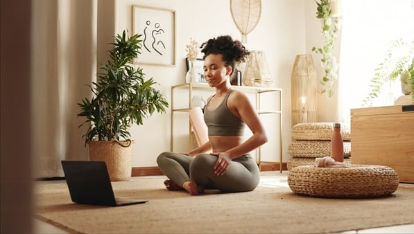 a woman sitting on the floor with a laptop and a laptop