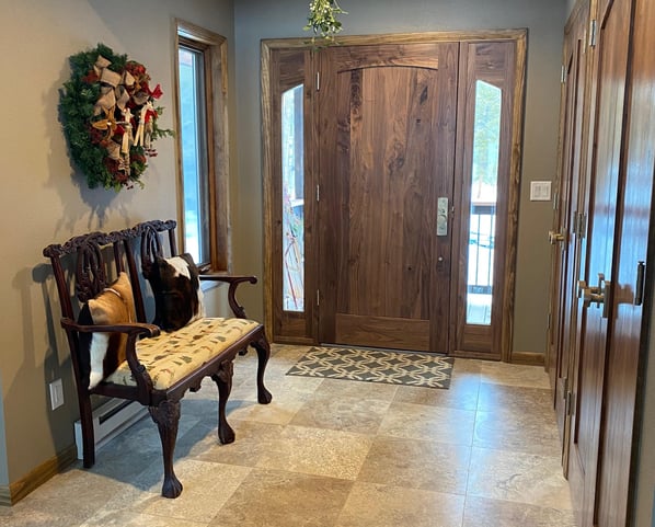 Entry way with a wooden bench and a chair
