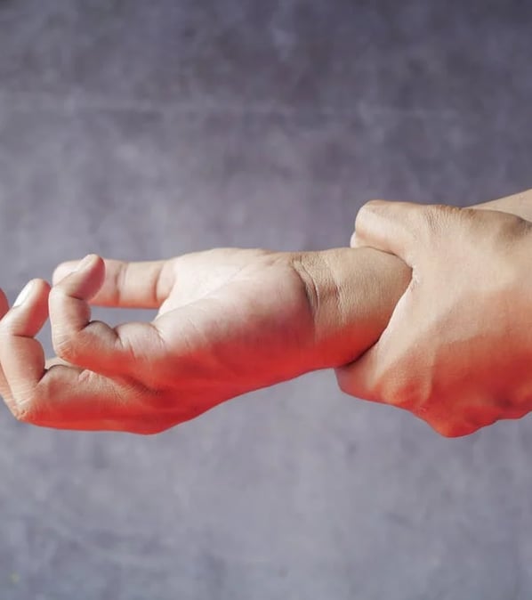 a person holding a hand with a finger on a wrist