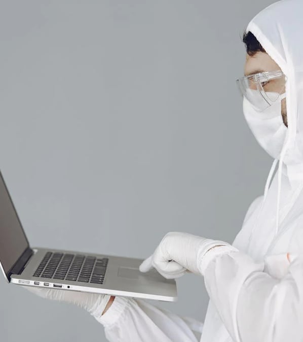 a man in a white lab coat and a white mask