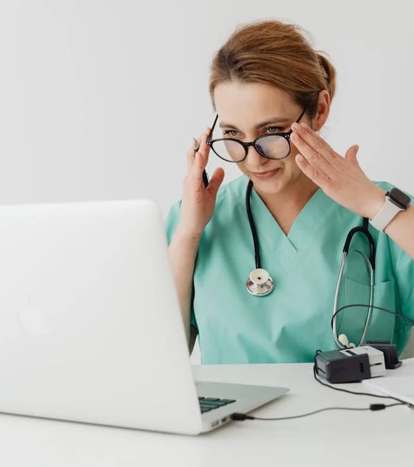 a woman in a green scrub suit and glasses