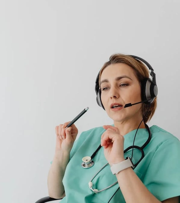 a nurse in a green scrub suit with a stethoscope attached to a