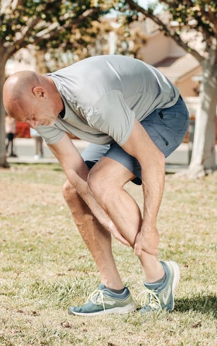 a man in a gray shirt is holding a frisbee