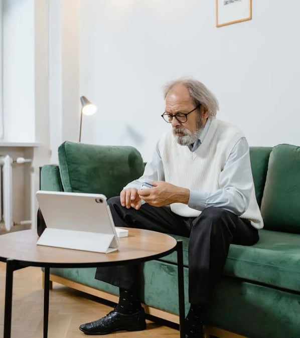 a man sitting on a couch with a laptop