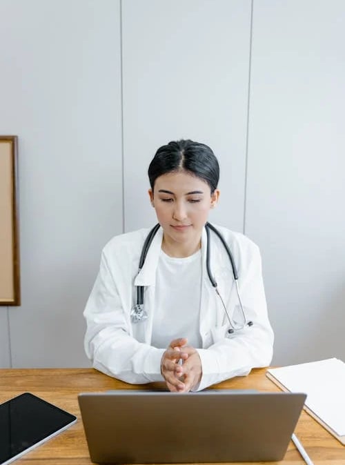 a woman in a white lab coat and a stethrobe