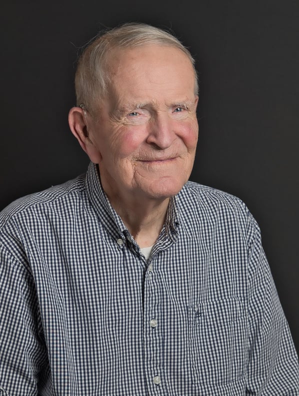 an old man in a blue shirt and a white shirt