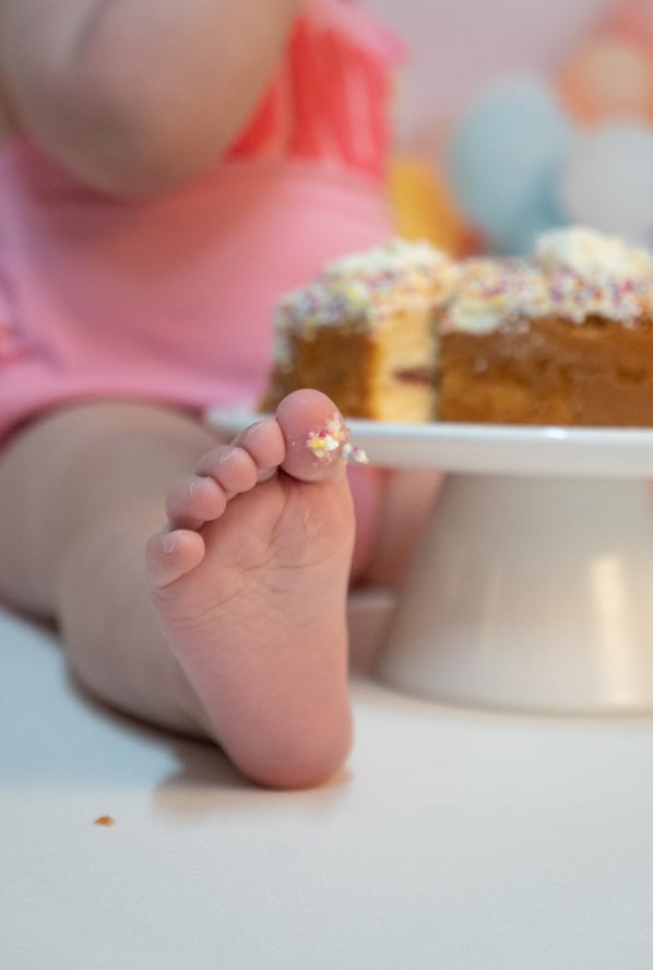 a baby's feet and feet on a cake