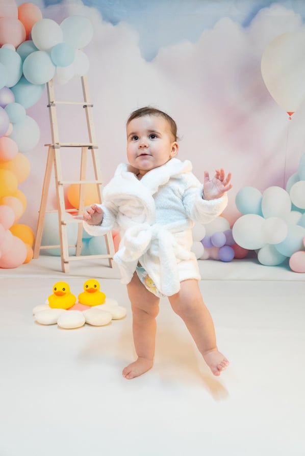 a baby in a white robe and a rubber ducky ducky